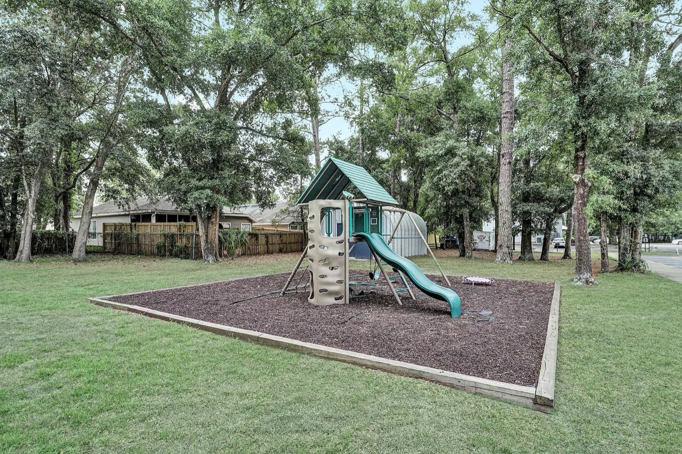 On-site playground beneath the oak canopy at The Haven