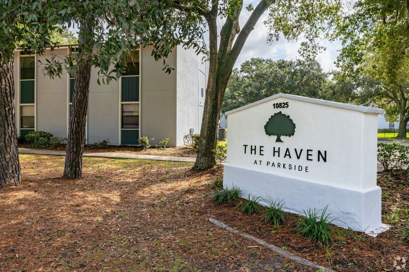 The Haven at Parkside welcome sign beneath oak trees
